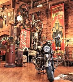 there is a motorcycle that is on display in the room with other things around it