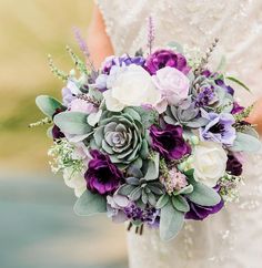 a bride holding a purple and white bouquet with succulents on it's side