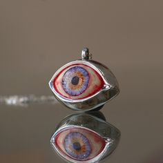 Blue Eye Pendant, Evil Eye Talisman Pendant, Glass Blue Eye Necklace, Evil Eye Necklace, Eye Jewelry, Gift Idea, Handmade Eye Jewelry My eye designs can be made specifically for your eyes, you need to take a beautiful iris photo for us. Then we can customize it for you. You can also add or remove blood details to our eye designs. You can write this in the order notes. Please send me a message after ordering. I can do as you wish. A quasi-universal symbol of protection, the evil eye is referred t Eye-catching Handmade Jewelry For Gifts, Eye-shaped Amulet Necklace As Gift, Eye-catching Evil Eye Jewelry For Gift, Amulet Eye Necklace Gift, Symbolic Eye-shaped Jewelry Gift, Blue Symbolic Collectible Jewelry, Unique Eye-shaped Jewelry For Gifts, Unique Evil Eye Necklace For Gift, Spiritual Eye-shaped Necklace For Gift