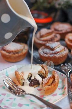 a person pouring syrup on some pastries