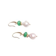 These stunning earrings are a delicate harmony of nature and elegance. At the heart of each piece is a luminous, irregularly shaped baroque pearl, with its organic luster adding a soft, ethereal glow. Stacked gently above the pearl is a smooth, circular green jade bead, offering a striking contrast with its deep, earthy hue. Between the two, a dainty flower spacer, finely crafted, adds a touch of intricate detail, creating a sense of balance and refinement. The entire arrangement is suspended fr Gold Hypoallergenic Jade Earrings, Unique Jade Drop Earrings, Luxurious Earrings, Luxury Green Jade Earrings, Luxury Jade Gemstone Earrings, Luxury Jade Cabochon Earrings, Luxury Earrings, September Birthstone Jewelry, Forever Jewelry