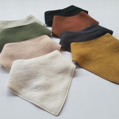 five different colors of cloth on a white surface