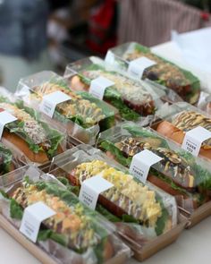 several trays filled with different types of sandwiches