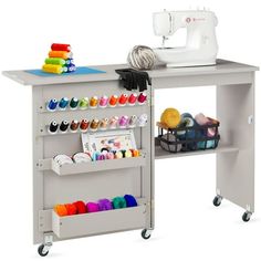 a sewing machine sitting on top of a table next to a shelf filled with craft supplies