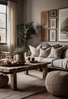 a living room filled with furniture and pictures on the wall next to a coffee table