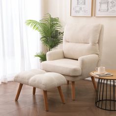 a living room with a chair and ottoman next to a potted plant in the corner