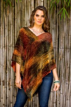 The colors that we chose for this poncho are inspired by how San Pedro Volcano looks when the sun is setting say the women of K'amolon K'i K'ojonel who boast their pride in their classic weaving techniques. Working on a back strap loom the design of this poncho is at once classic and contemporary . A rich blend of cotton and bamboo fiber assures the soft warmth of this trendy poncho in brown dark red orange and green. Since the threads are dyed by the women please expect slight differences in th Kids Fashion Show, Fashion Show Dresses, Bamboo Fiber, Orange And Green, Design Patterns, San Pedro, Knit Outfit, Back Strap, Volcano