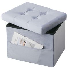 a blue ottoman with magazine storage underneath it