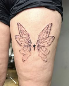 a woman's thigh with a butterfly tattoo on it