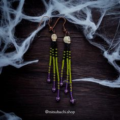 Add a touch of spooky elegance to your collection with these stunning dangle earrings! Featuring tiny white skulls, these earrings are accented with purple, black and green seed beads. Perfect for Halloween or any occasion where you want to stand out! Drop Length: Approximately 3 inches Ear Wire Hooks: Copper Lightweight Design: Comfortable for all-day wear Unique Gift: Ideal for Halloween lovers! Handmade Purple Halloween Earrings, Beetlejuice Halloween, Earrings Beads, Pagosa Springs, Halloween Beads, Halloween Lovers, Beaded Skull, Halloween Skull, Bead Earrings