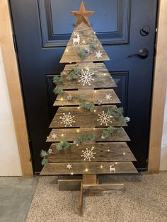 a wooden christmas tree with lights on it