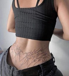 a woman's stomach with an intricate tattoo on her lower body and bottom part