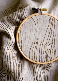 a close up of a wooden hoop on a fabric