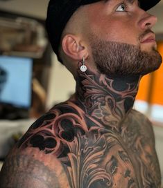 a man with tattoos on his neck and chest