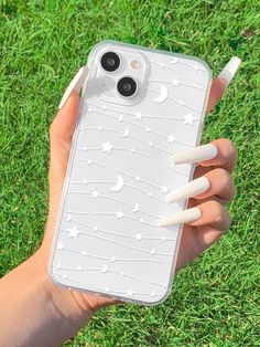 a person holding an iphone case in their hand on the grass with nail polishes