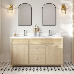 a bathroom with two sinks and mirrors on the wall