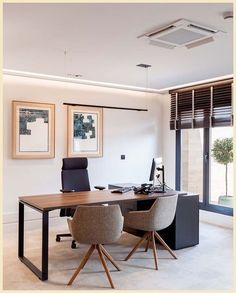 an office with two chairs and a desk in front of a large sliding glass door