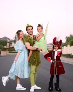 a family dressed up as peter pan, tinkerbell and the great fairy tale