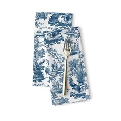 two blue and white napkins with silverware on top of each one in front of them