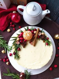 a white plate topped with a frosted cake covered in icing and christmas decorations