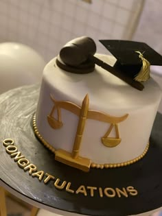 a cake that has a scale and a judge's hammer on it with congratulations written on the side