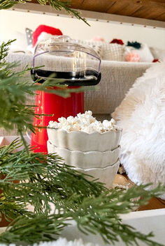 a living room filled with furniture and christmas decorations