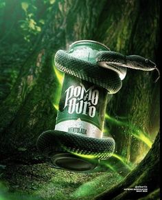 a can of soda with a snake wrapped around it's neck in the woods