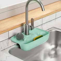 a sink with a soap dispenser on the side and a sponge under it