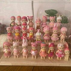 a bunch of little dolls that are on a table