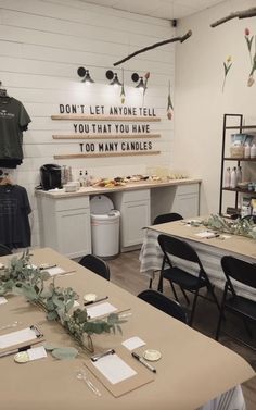 a room with tables, chairs and signs on the wall