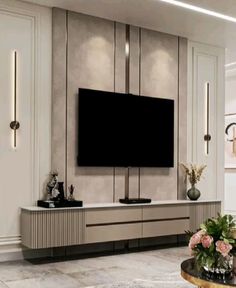 a large flat screen tv mounted to the side of a wall in a living room