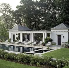 a house with a pool in front of it and some chairs around the pool area