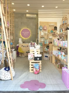 the inside of a store with lots of items on shelves and ladders in it