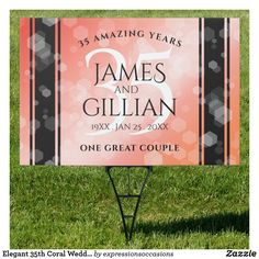 a pink and black wedding sign in the grass