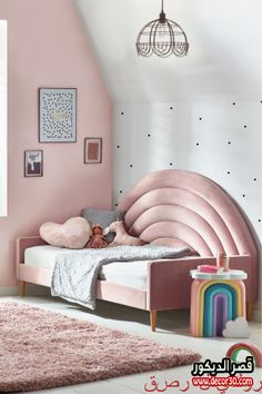 a child's bedroom with pink walls and furniture