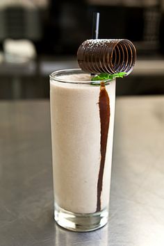 a glass filled with milk and chocolate on top of a table