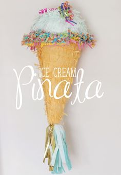 an ice cream cone with tassels and streamers on it that says, ice cream pinata