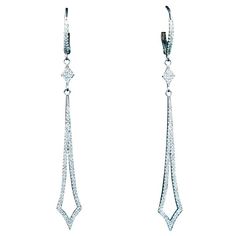 These stunning earrings feature a sharp streamline design with pave diamonds throughout. Specs below. In excellent condition. Please feel free to ask any questions you may have, we are happy to assist. Specs: 14KT White Gold Diamonds: Round Cut Diamonds with an approximate carat weight of 0.44cts Length: 2 3/8" Width: 1/4" Pave Earrings, Earring Sets, Pearl And Diamond Earrings, Streamline Design, Spiral Earrings, Earrings Drop, Diamond Drops, Diamond Drop Earrings, Stunning Earrings