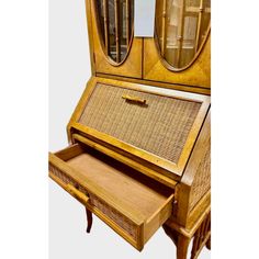 an antique wooden desk with drawers and mirror