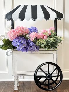 a wagon with flowers in it sitting on the floor