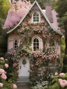 a pink house covered in flowers and vines