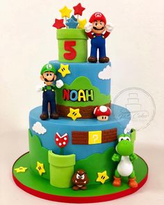 a three tiered cake with mario and luigi on top