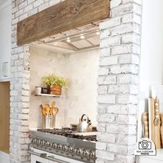 a stove top oven sitting inside of a kitchen next to a wall with shelves on it