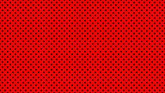 a red background with black dots