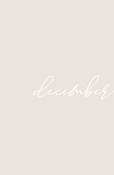 the word december written in cursive writing on a light gray background with white ink