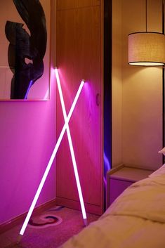 a bedroom with a pink light in the corner