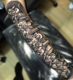 a man's arm with an image of the last supper tattoo on his forearm