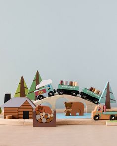 a wooden toy set with cars, trucks and animals