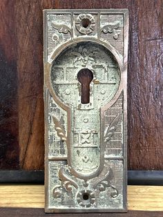 an old metal door handle on a wooden door