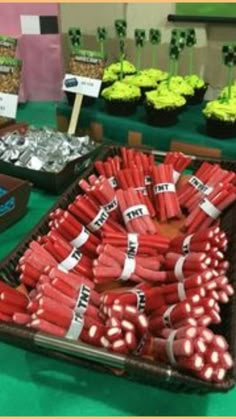 a table filled with lots of different types of candy and cupcakes on top of it